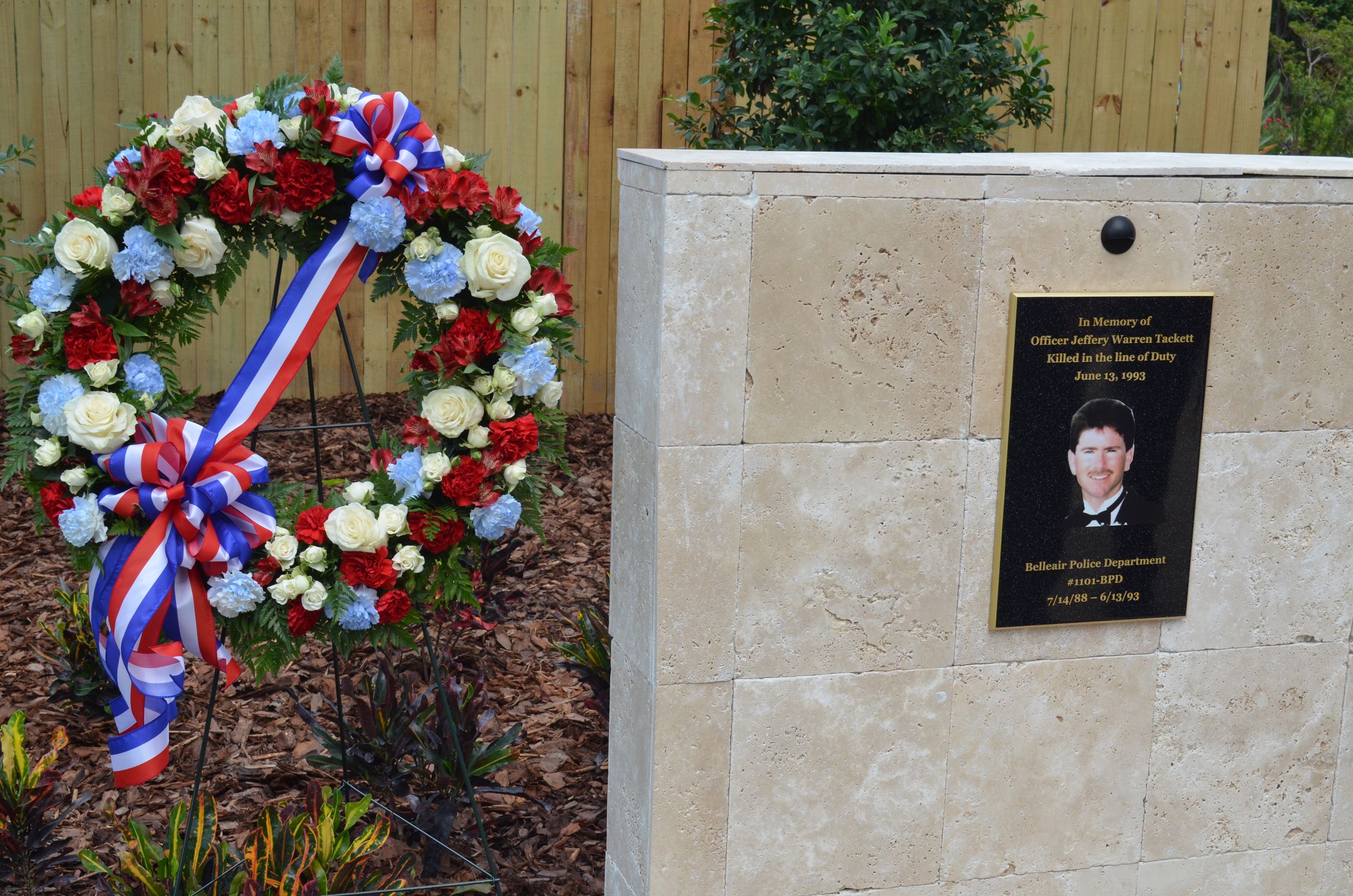 Jeffery W. Tackett memorial plaque and floral wreath.