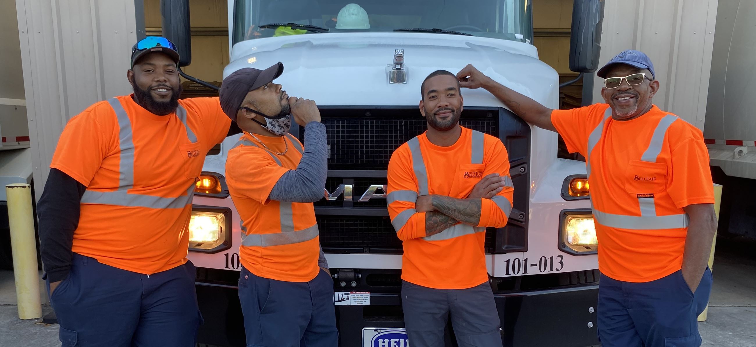 Belleair's solid waste team poses for a group photo in front of the garbage truck. 